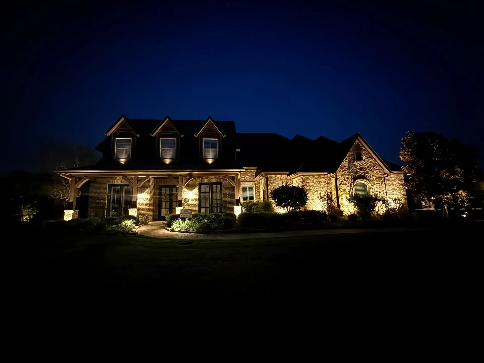 house and landscape lighting at blue hour